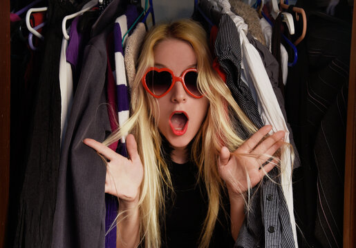 Fashion Woman in Closet with Too Many Clothes