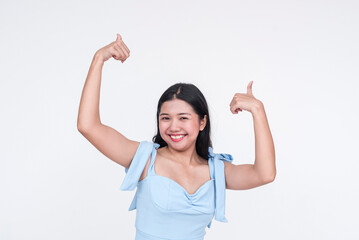 Young Asian woman in powder blue dress giving thumbs up, isolated on white
