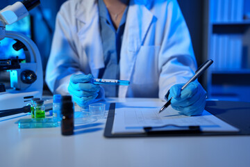 Scientists record data using drug sampling tubes for analysis and testing. Advanced science...