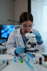 Confident female scientist conducting research in medical laboratory A researcher in the foreground...