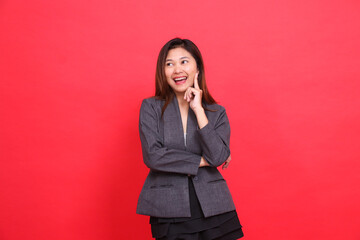 gesture of an Asian office woman who got the idea of arms crossed, wearing a gray jacket and black...