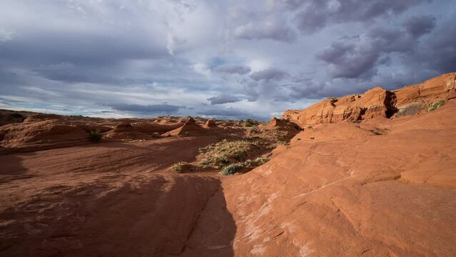 Timelapse of clouds moving over the Escalante desert in Utah, as the sandstone is glowing.