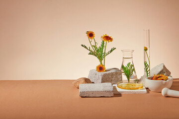 Liquid extracted from Calendula flowers filled inside few glassware, arranged with some blocks of...