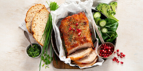 Sliced baked ham with salad on light wooden background. Traditional food concept