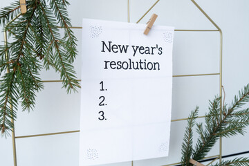 NEW YEAR'S RESOLUTION paper note on Dream board promises and aims. Preparation for new year new...