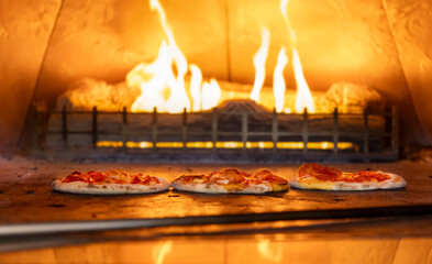 Pizza cooking in a wood burning oven