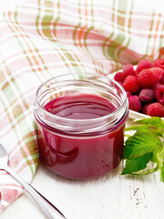Jam of raspberry in jar on table