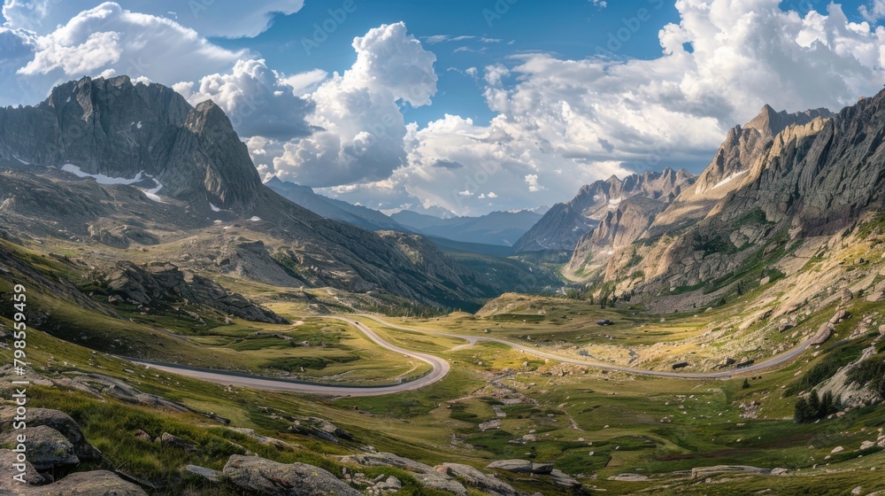 Poster a panoramic shot of a scenic mountain highway, surrounded by towering peaks and winding its way thro
