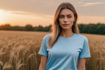 woman standing in field wearing light blue t-shirt, t-shirt mock-up, 