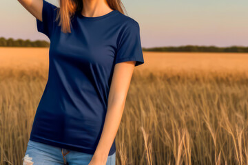 woman standing in field wearing navi blue t-shirt, t-shirt mock-up, face not visible 