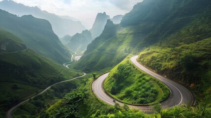 A winding mountain road snaking through lush greenery, offering breathtaking views of the valley below and the peaks above.