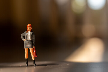 Miniature people ,  A businesswoman standing alone with a suitcase