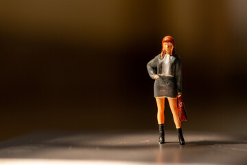 Miniature people ,  A businesswoman standing alone with a suitcase