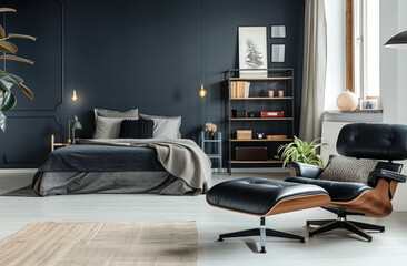 Black bedroom with bed, Eames chair and bookcase in the style of boho chic