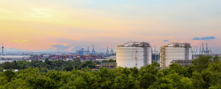 Panorama view of heavy industrial estate including crude oil industry and logistics port that located next to high density forest which create pollution and contamination to the wildlife