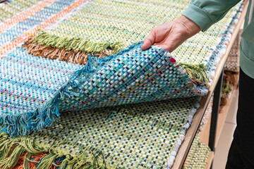 A woven rug made of old things. Eco-friendly development. Reuse of items. Handmade work.
