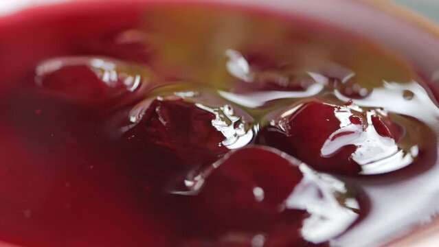 close up of colorful berry bruit jelly on plate on table,