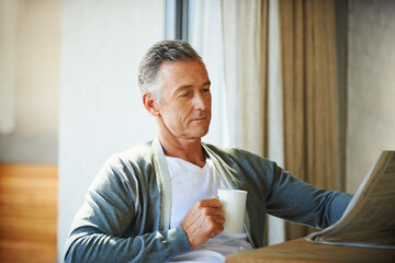 Mature, man and newspaper for reading in home, relax and information or articles in morning with coffee. News, breakfast table and rest and calm for entertainment pages, current events in apartment