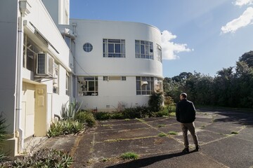 Man looking upto up to historical building at Musick Point in Bucklands Beach., Auckland, New Zealand.