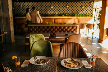 Food leftovers in a restaurant, people in the background leaving