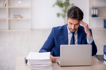 Young male employee working in the office