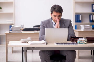 Young male employee working in the office