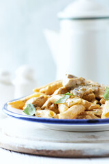 Penne Pasta baked with Meat on bright wooden Background. Close up.