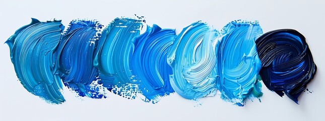 A series of strokes in different shades and types of blue paint, arranged on white background, with one stroke appearing more vibrant than the others