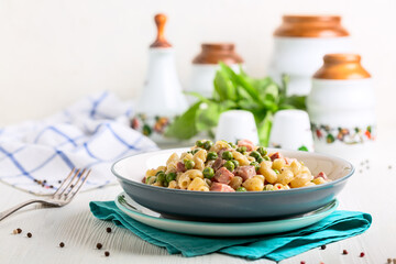 Homemade pasta with green peas and ham.