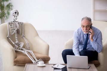 Old male psychologist meeting with skeleton