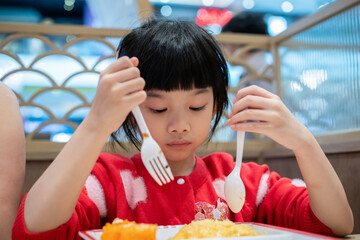 Cute little asian child girl eating food