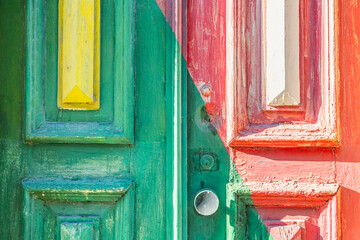 Old wooden door with shabby colorful paint close up. Traditional architecture in Porto, Portugal.