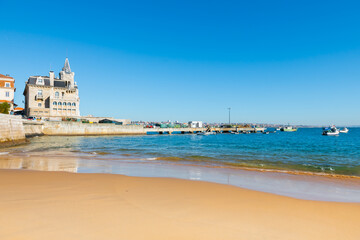 Cascais, Portugal. Beautiful coast of Atlantic ocean with blue water and yellow sand
