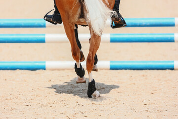 Sand from under the pony's hooves. Pony hooves when approaching the barrier. Equestrian sport. Pony...