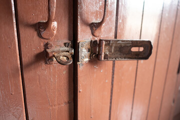 Old rusty latch on a wooden door