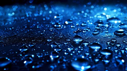   A tight shot of water droplets on a dark backdrop, tinted blue to the left and right