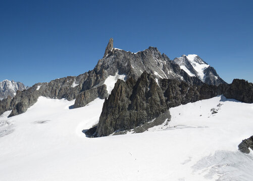 View of the Giant´´´´  s Tooth in the mountainsides of the Mont-Blanc during the summer from the Pointe Helbronner. Alps Mountains. Border between Italy and France.