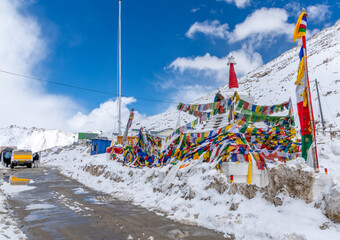 Prayer flags at the summit of Changla Pass at 17,586 feet in the Himalayan Mountains in northern...