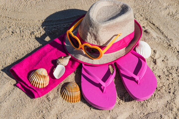 Different accessories using for relax on beach. Straw hat, flip flop, sunglasses and towel. Summertime