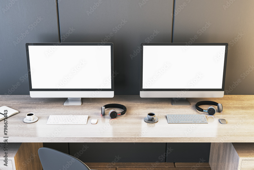 Aufkleber two empty white gaming computer screens on desk with coffee cups and headsets. place for your advert