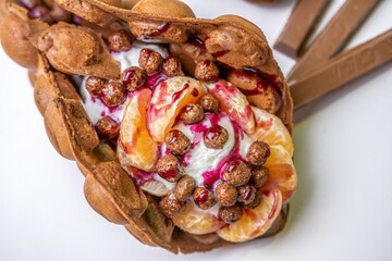 Hong Kong waffle with ice cream, topping, berries and sweets