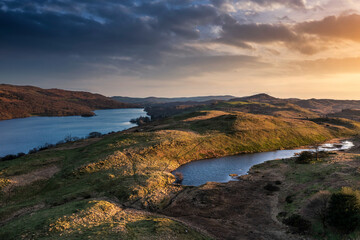 Stunning, Spring sunset landscape aerial drone image in Lake District looking towards Old Man of Coniston