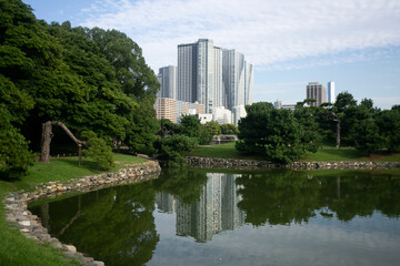 Fototapeta premium The Gardens of Hamarikyu are a public park in Chūō, Tokyo, Japan. Located at the mouth of the Sumida River they are surrounded by modern buildings.