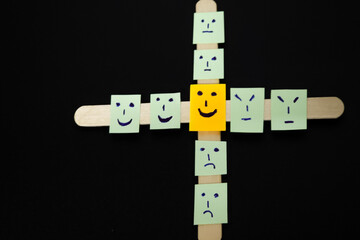 concept for positive attiude with sall office notes with multiple face with blackbaground,attitude, positived
