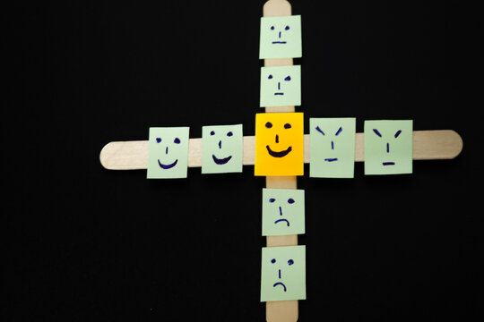 concept for positive attiude with sall office notes with multiple face with blackbaground,attitude, positived