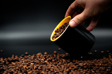 coffee beans and hand holding cup 