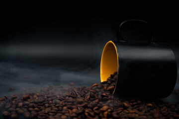 coffee beans and cup on black background close up with smoke 