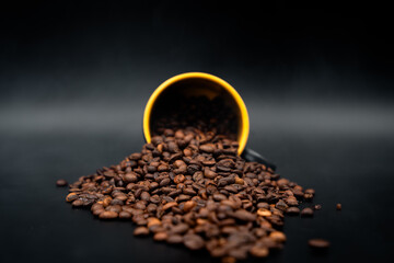 coffee beans in a cup on black close up