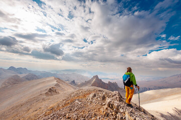 Adventure in the mountains. climber with a backpack in the mountains. Tourist traveling to the...