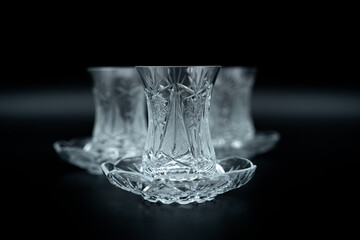 crystal tea glass on black background close up
